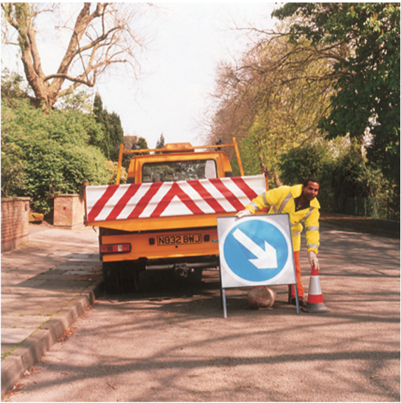 Vehicle with directional sign behind it