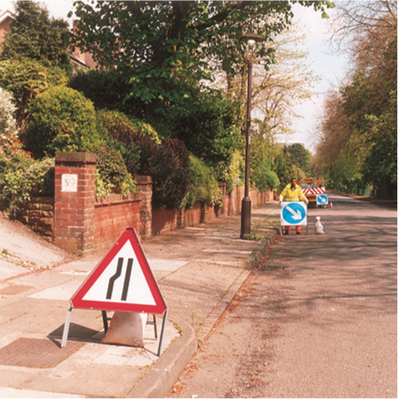 Man placing directional sign